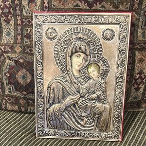 Silver plated icon tinted lithograph faces under plastic shield origin unknown